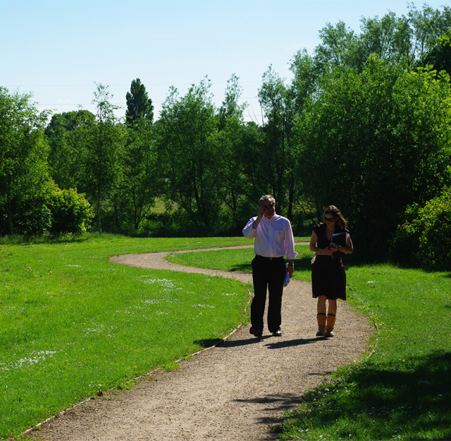People walking down a park trail.