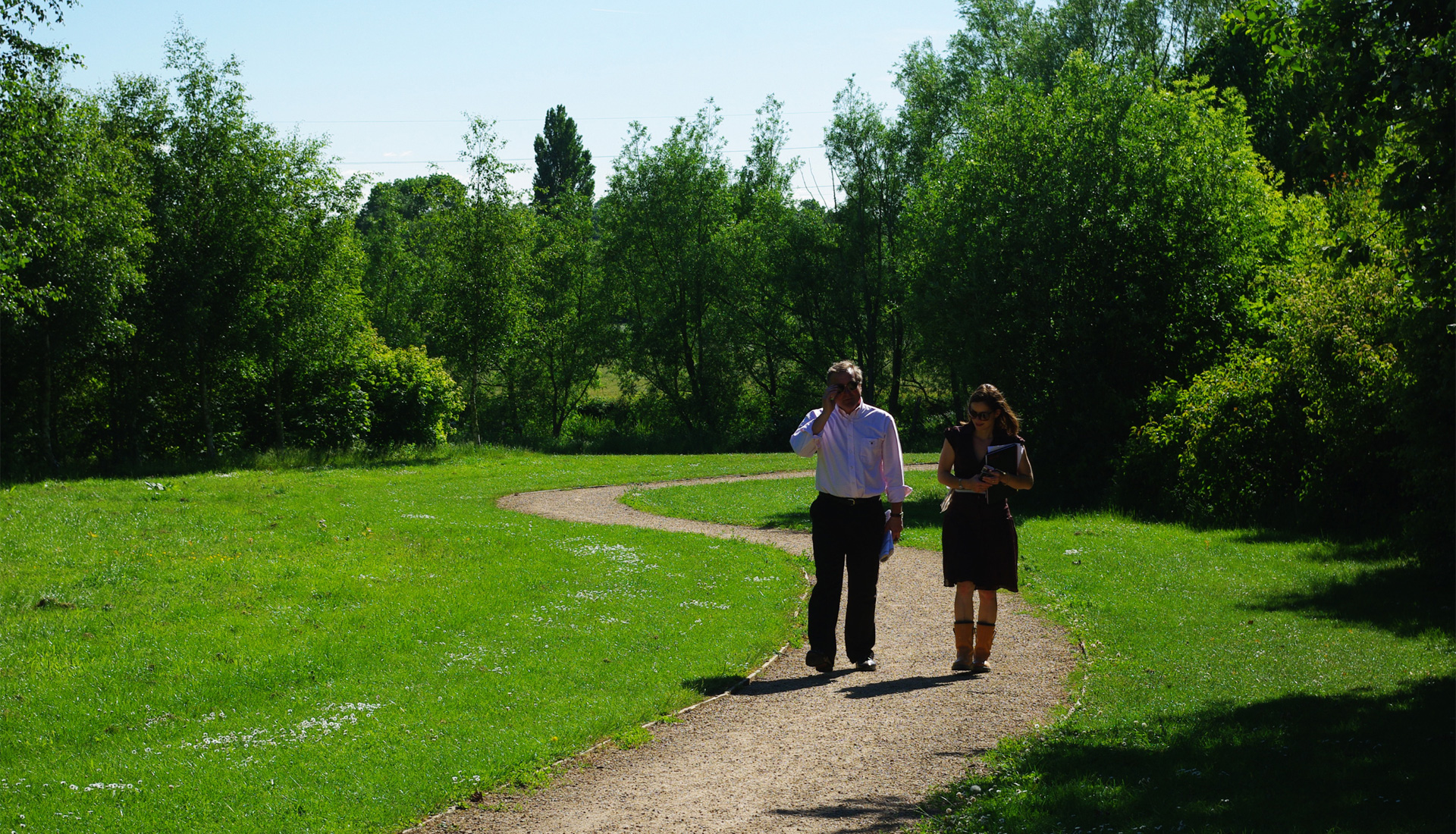 People walking down a park trail.